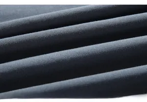 Close-up of dark grey-blue knitted fabric texture with soft brushed finish and drape