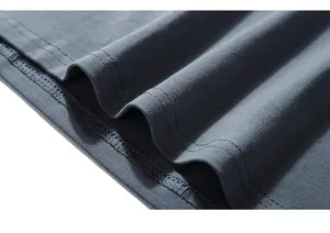Detailed close-up of double-stitched hem on dark gray knit long sleeve T-shirt