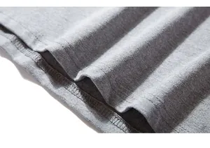 Macro shot of gray cotton T-shirt hem showing double-needle stitching and fabric texture