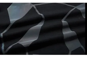 Macro detail of high-quality black knit fabric with gray geometric matte printed patterns