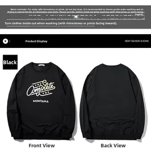 Detail of black crewneck sweatshirt with 'YOU COMPLETE YOU' rhinestone typography and ribbed cuffs