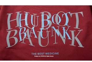 Detailed macro view of screen printed artistic lettering on maroon cotton fabric