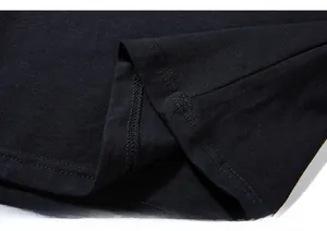 Macro detail of high-quality double-needle stitching on black knit cotton t-shirt fabric