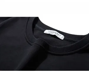 Close-up of the ribbed crew neck and 2XL size label on this premium black cotton sweatshirt