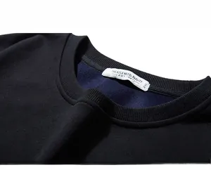 Detail showing the ribbed neckline and internal reinforced seams of a thick men's sweatshirt