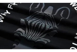 Detail shot of black cotton fabric with reflective French Bulldog and white lettering