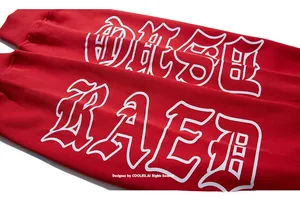 Close-up of red cotton sweatshirt sleeves with white gothic letter printing and ribbed cuffs