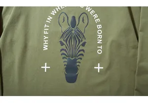Close-up of zebra graphic and motivational text print on olive green cotton t-shirt