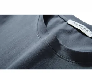 Close-up of deep gray cotton crew neck T-shirt with ribbed collar and size 3XL label