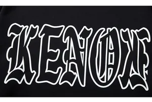 Detail shot of the white KENOX graphic print on a black oversized cotton sweatshirt