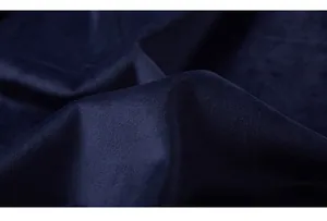 Close-up of thick navy blue velvet fabric with soft sheen and premium plush texture