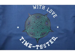 Detail of blue knit fabric showing geometric star print with vintage American lettering