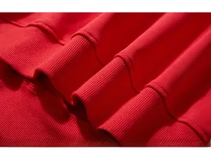 Close-up of high-density red cotton knit fabric with premium ribbed cuffs on the hoodie
