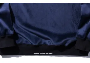 Macro shot of dark blue velvet fabric featuring elastic black ribbed cuffs and hem texture