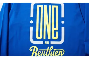 Detailed view of yellow and white graphic print on blue long sleeve cotton t-shirt