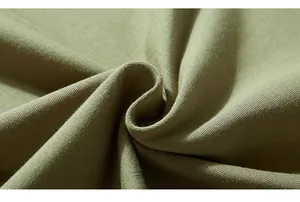 Detailed macro view of olive green knitted fabric texture and premium soft material
