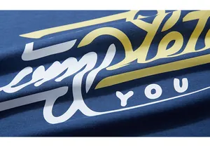 Macro detail of navy blue knit fabric with yellow and white artistic letter printing