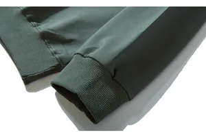 Detail of high-density cotton knit fabric and ribbed elastic cuffs on olive hoodie