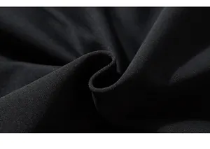 Detailed macro shot of premium heavy black knitted cotton fabric texture and soft drape