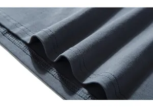Close-up of double-stitched hem on grey-blue long sleeve t-shirt fabric texture