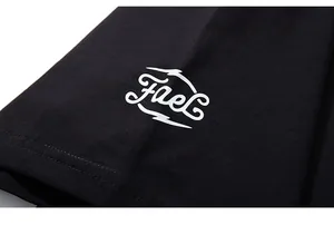 Close-up of white Fael logo printing on black cotton oversized t-shirt sleeve cuff