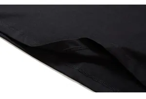 Close-up of double-needle stitching and hem detail on black cotton graffiti t-shirt