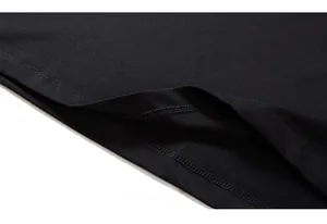 Close-up of double-needle stitching and high-density cotton hem on a black t-shirt