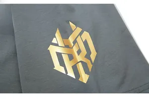 Macro shot of metallic gold geometric print on dark grey knit cotton T-shirt