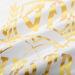 Oversized white T-shirt featuring high-quality gold foil crest print on cotton fabric