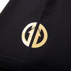 Oversized black cotton T-shirt featuring a metallic gold circular street style logo