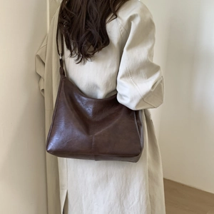 Minimalist dark brown leather shoulder bag with vertical stitching for women