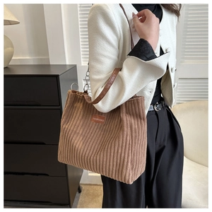 Detail of autumn corduroy tote bag with leather straps and metal chain texture