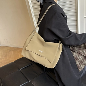 Chic khaki faux leather tote bag with metal chain strap and white fashion lettering