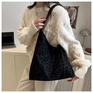 Detailed view of the black leopard print texture on this vintage shoulder tote bag