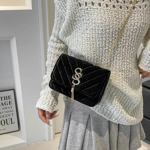 Fashionable black velvet shoulder bag with V-quilted pattern and gold chain strap