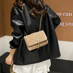 Elegant beige quilted velvet crossbody bag with golden chain and tassel detailing