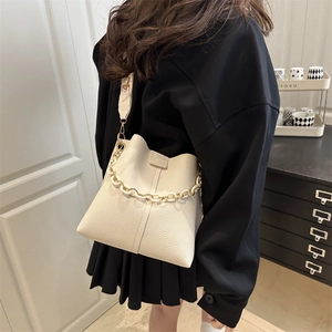 Cream litchi pattern bucket bag with decorative acrylic chain and wide shoulder strap