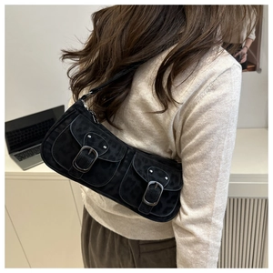 Detail of black baguette bag with leopard texture and dual utility silver buckle pockets