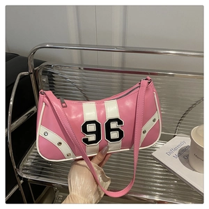 Detail view of pink and white faux leather underarm bag with 96 patch and silver rivets
