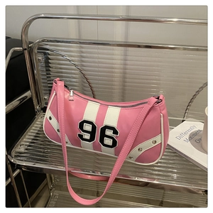 Detailed view of the pink and white striped bag with number 96 embroidery and studs