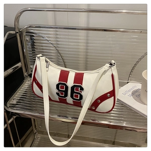 Close-up of retro white shoulder bag with red stripes and number 96 on a modern stand