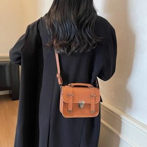 Retro orange crossbody bag for women featuring silver metal locks and adjustable strap
