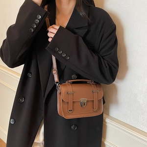 Retro brown leather crossbody bag for women with top handle and metal buckle closure