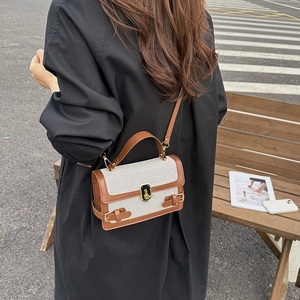Retro cream canvas crossbody bag with brown leather trim and metallic gold lock buckle