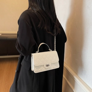 White quilted crossbody bag with silver twist lock and chain strap for women