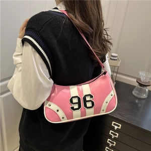 Pink and white Y2K style retro underarm bag with number 96 patch and silver studs