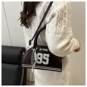 Detail view of dark brown bowling bag with Los Angeles print and metal chain strap