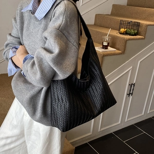 Chic black woven hobo tote bag with a minimalist design for women's autumn winter fashion