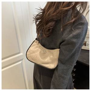 Detail of glitter fabric texture and diamond quilting on stylish beige shoulder bag