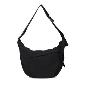 Minimalist black crescent tote bag with adjustable wide strap and texture details